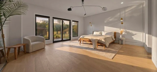 Made bed in a bright bedroom after a clean