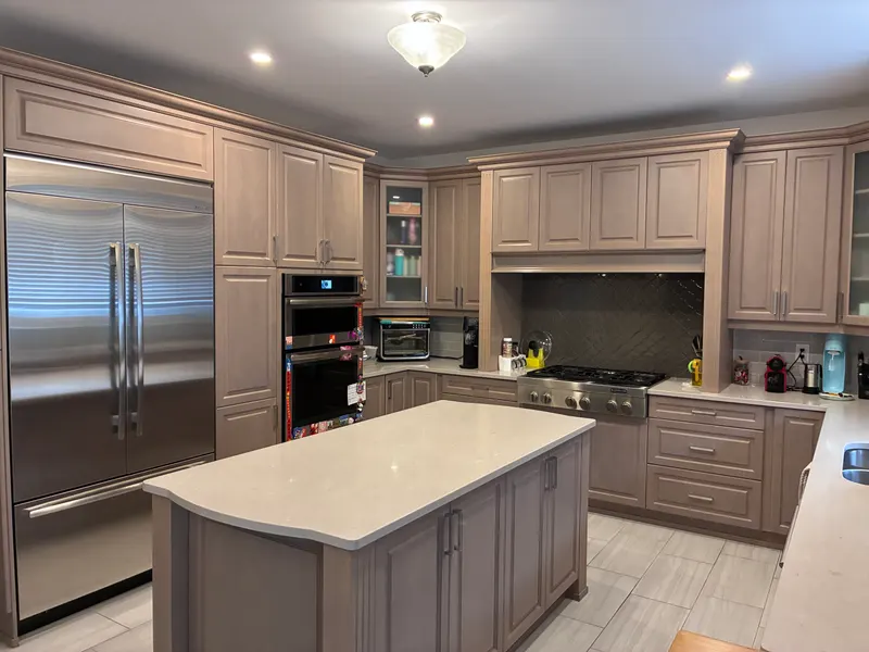 Clean kitchen with an island and stainless appliances