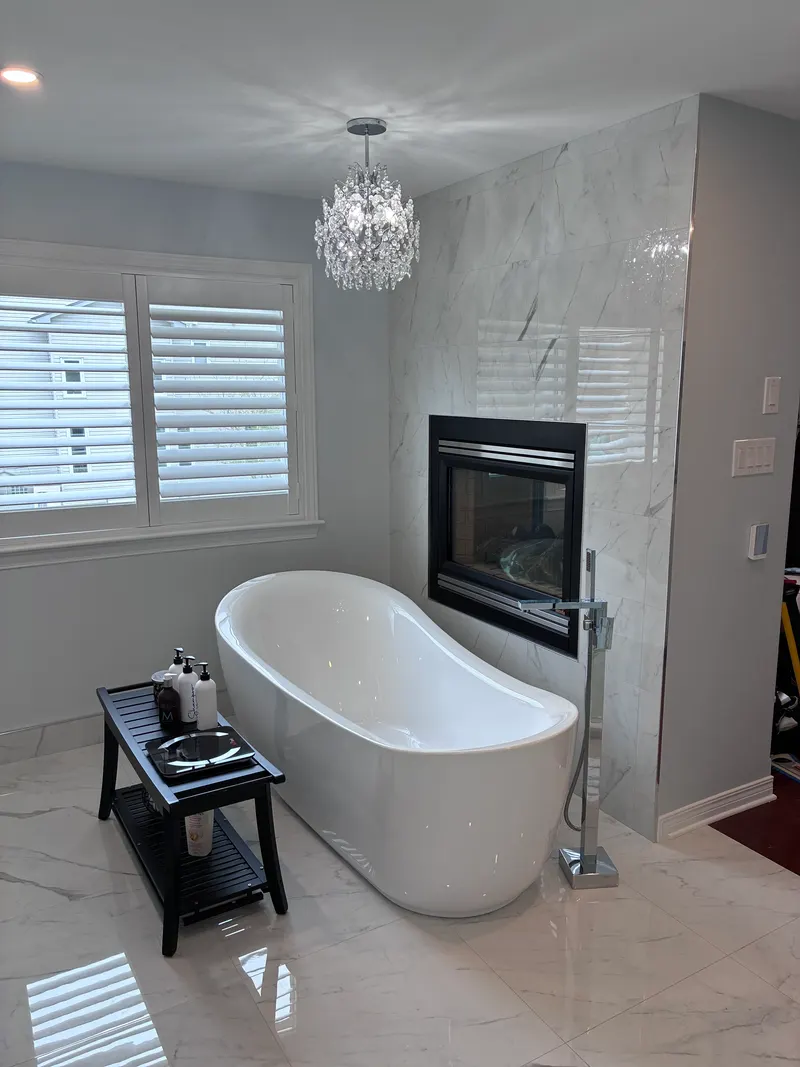 Freestanding tub and fireplace in a cleaned ensuite