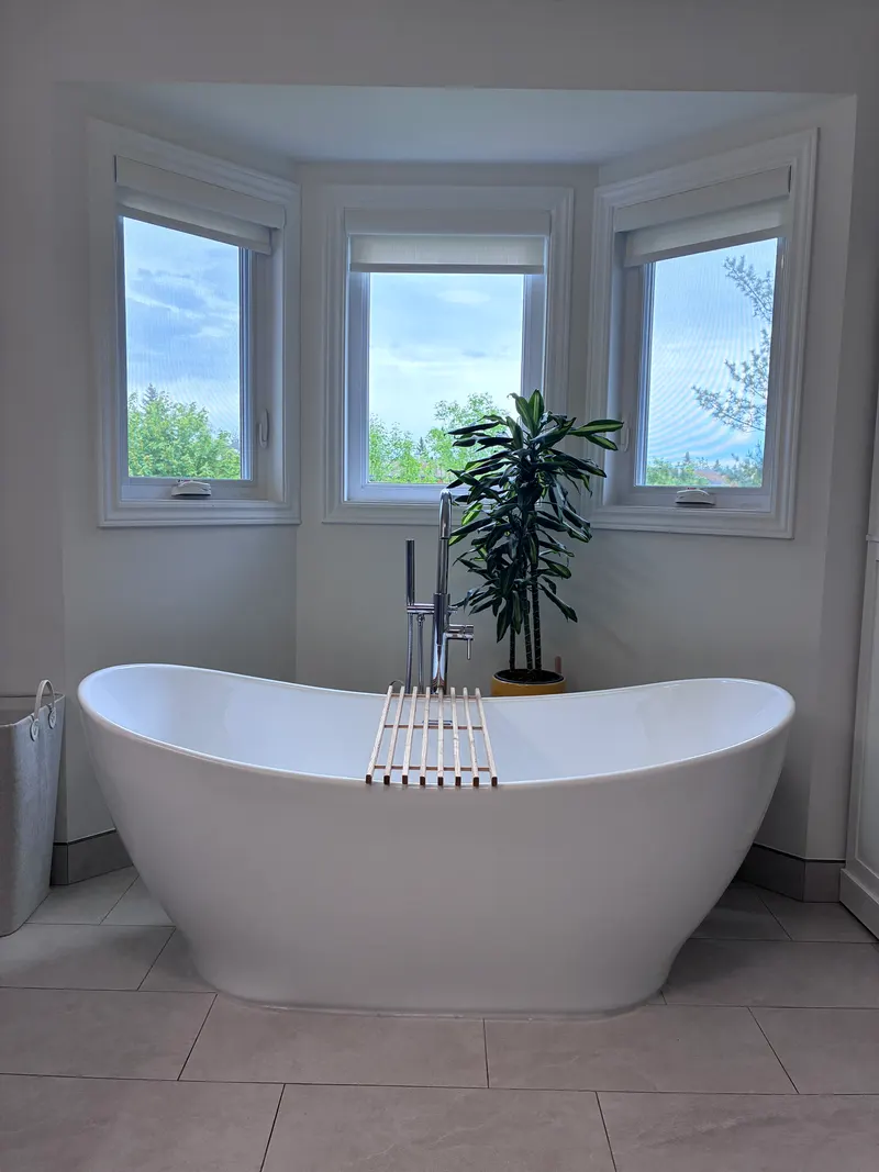 Freestanding tub under a row of windows
